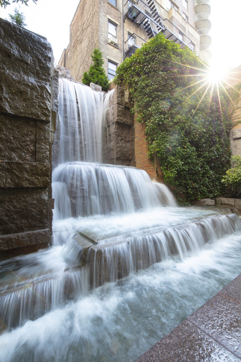 A waterfall with water pouring over it.